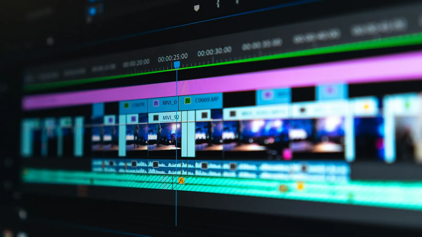 Video editing timeline with colored clips on a dark screen