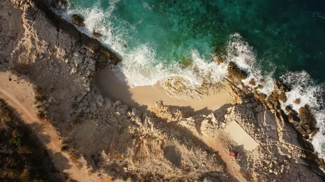 Drone shot of waves breaking on a rocky coastline